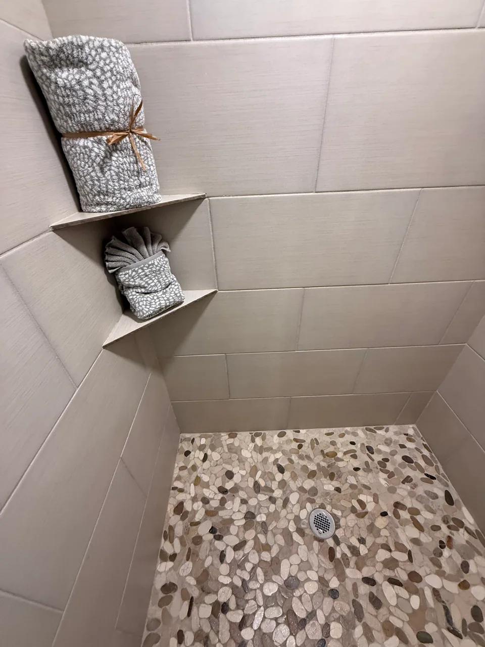 Walk-in shower with tile surround and glass enclosure
